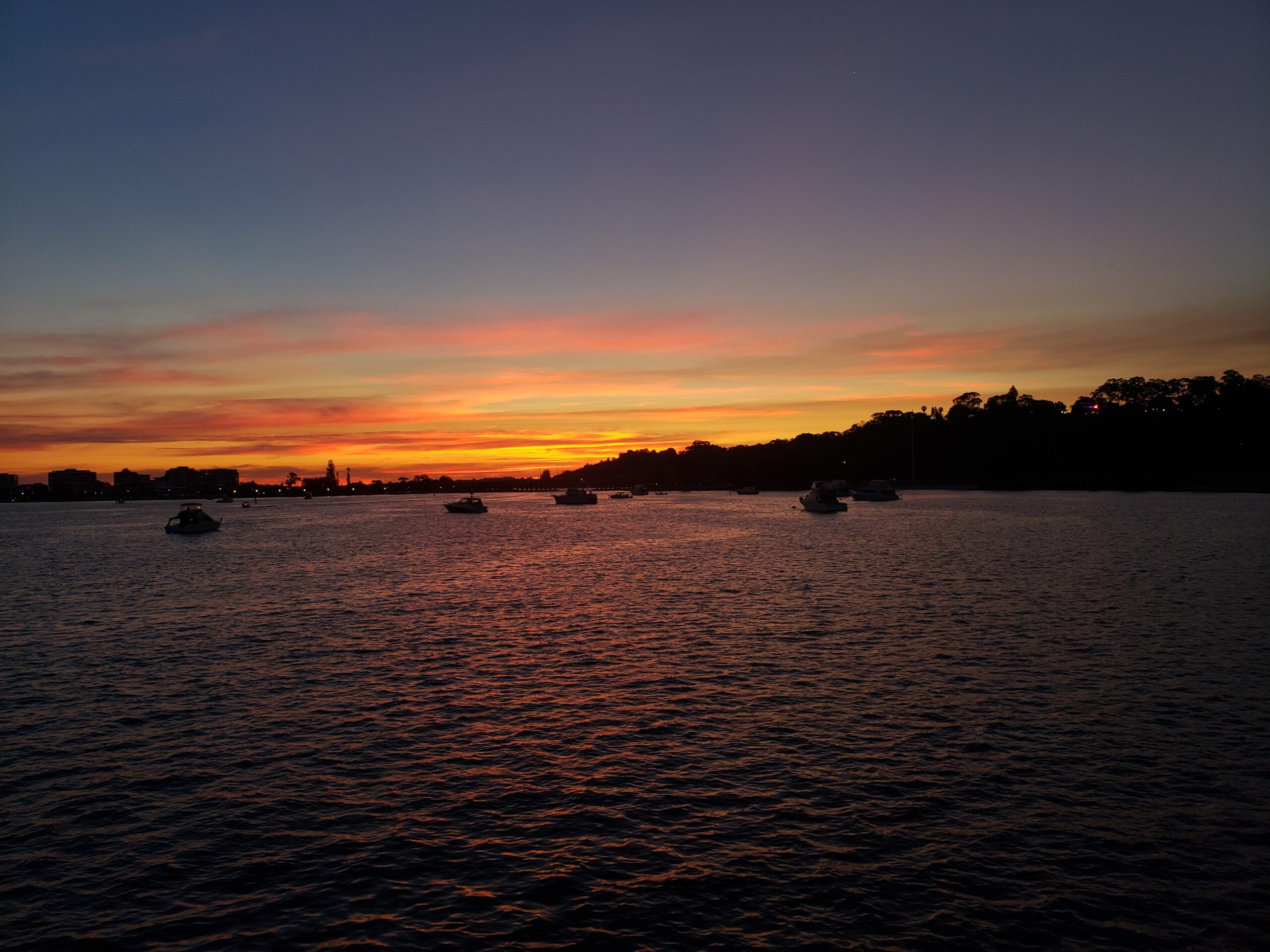 Boats near the shore at sunset, scenic landscape for CruVideos nature content